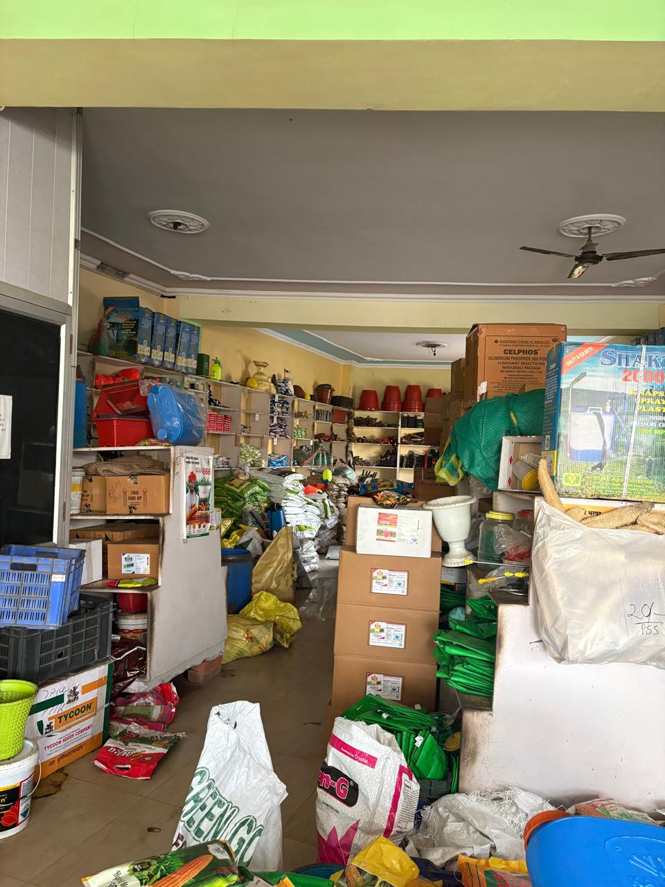 Cluttered store aisle with gardening supplies