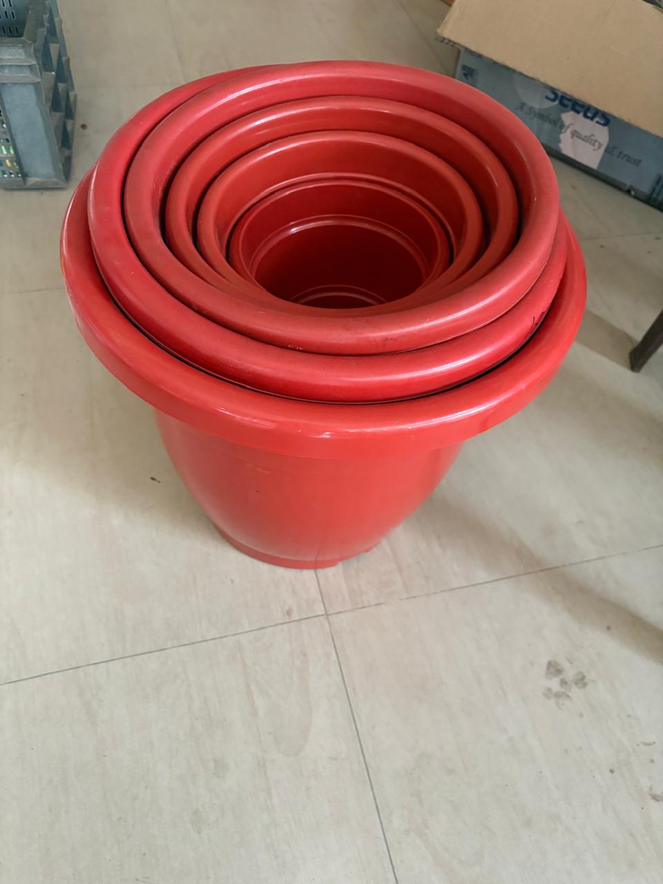 Red plastic flower pots stacked together
